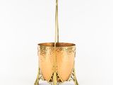 brass planter with two handles on a white background