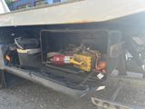 the back end of a truck with tools in the back