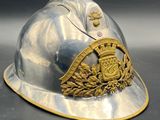 a silver and gold helmet with a crest on it
