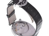 a watch that is sitting on a white surface