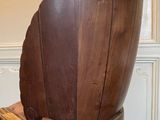 a chair that has a shell on it in the middle of a room