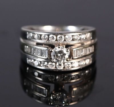 a close up of a diamond ring on a black surface