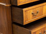 an image of a wooden dresser with three drawers and a drawer underneath it