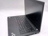 a black laptop with a black keyboard on a white surface