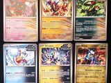 a lot of different pokemon cards on the table