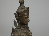 bronze statue of a woman with a bird on her head