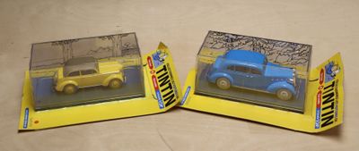 two toy cars that are in a box on a table