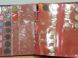 a red binder with coins in it on a table