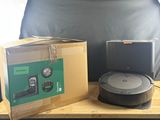 two boxes of vacuum cleaners on a table next to a chair