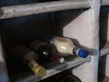 many bottles of wine sitting on the shelves in the room