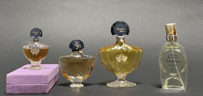 three bottles of perfume sitting next to each other on a table