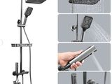 an image of a shower head with thermostaer and hand held shower head