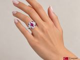 woman ' s hand with pink manicured nails and a white and pink ring