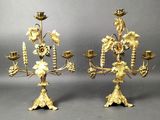 pair of gold plated candelabs with flowers and leaves