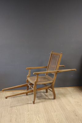an image of a wooden chair in a room with a gray wall
