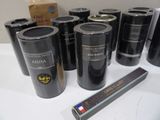 bottles of wine are lined up on a table next to a ruler