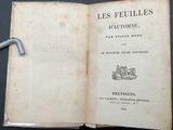 an open book with a handle on top of it on a table