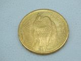 a close up of a coin on a white surface