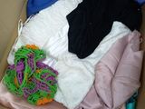 a box full of clothes that is sitting on the floor