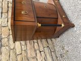 a small wooden chest sitting on a cobblestone street