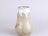 a small vase that has a white substance on it