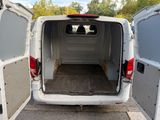 a white van with its doors open in a parking lot