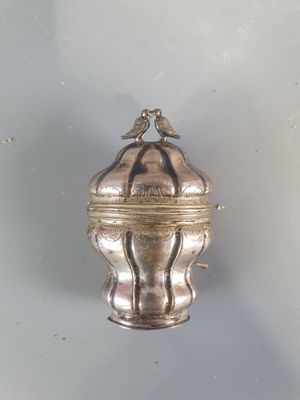 a silver box with a bird on top of it