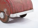a red toy truck that is sitting on a white surface