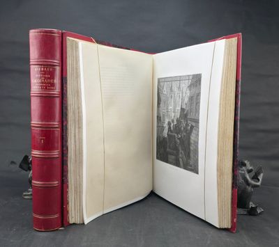 an open book sitting on top of a table next to a statue