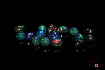 a close up of a group of oplite beads on a black surface