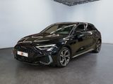 a black car parked in a large room with a white wall