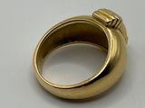 an image of a gold ring sitting on top of a white surface