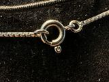a close up of a necklace on a mannequin mannequin head