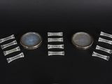 four pieces of glass sitting on top of a black table