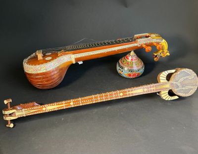 two pieces of musical instruments sitting on top of a black surface