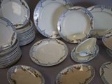 a lot of plates and bowls sitting on a table