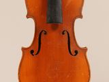 an old violin with a bow hanging from it ' s back