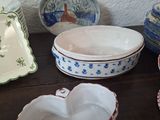 many different types of plates and bowls on the table