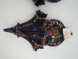 pair of decorative wall clocks on a white surface