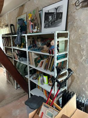 a bookshelf in the corner of a room with a lot of books