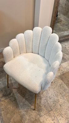 a white chair that is sitting on a tile floor