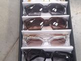 several pairs of glasses are in a display case on the floor