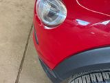 a close up of a car ' s headlight on a sidewalk