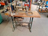 a sewing machine that is sitting on a table in a room
