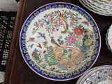 a plate with a bird on it sitting on a table