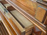 a wooden bench with a mirror on top of it