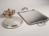 a silver tray with a mirror and a teapot