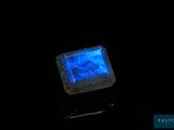 an image of a glowing blue stone on a black surface
