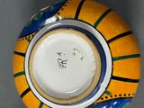 a yellow and blue bowl with a cat on it