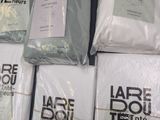 a lot of white shirts on display in a store